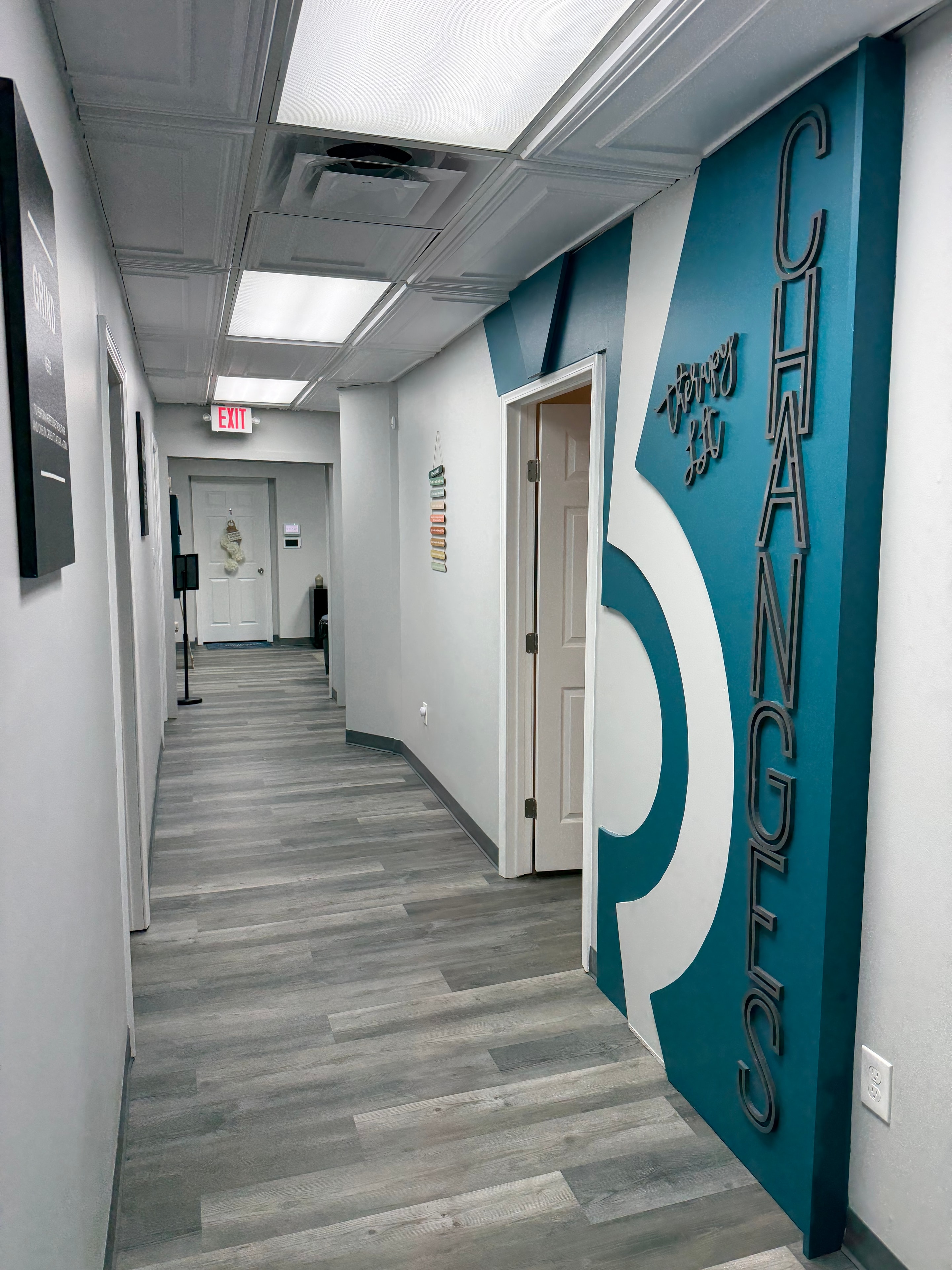 Hallway at Changes Therapeutic Services featuring the teal Changes branding wall mural