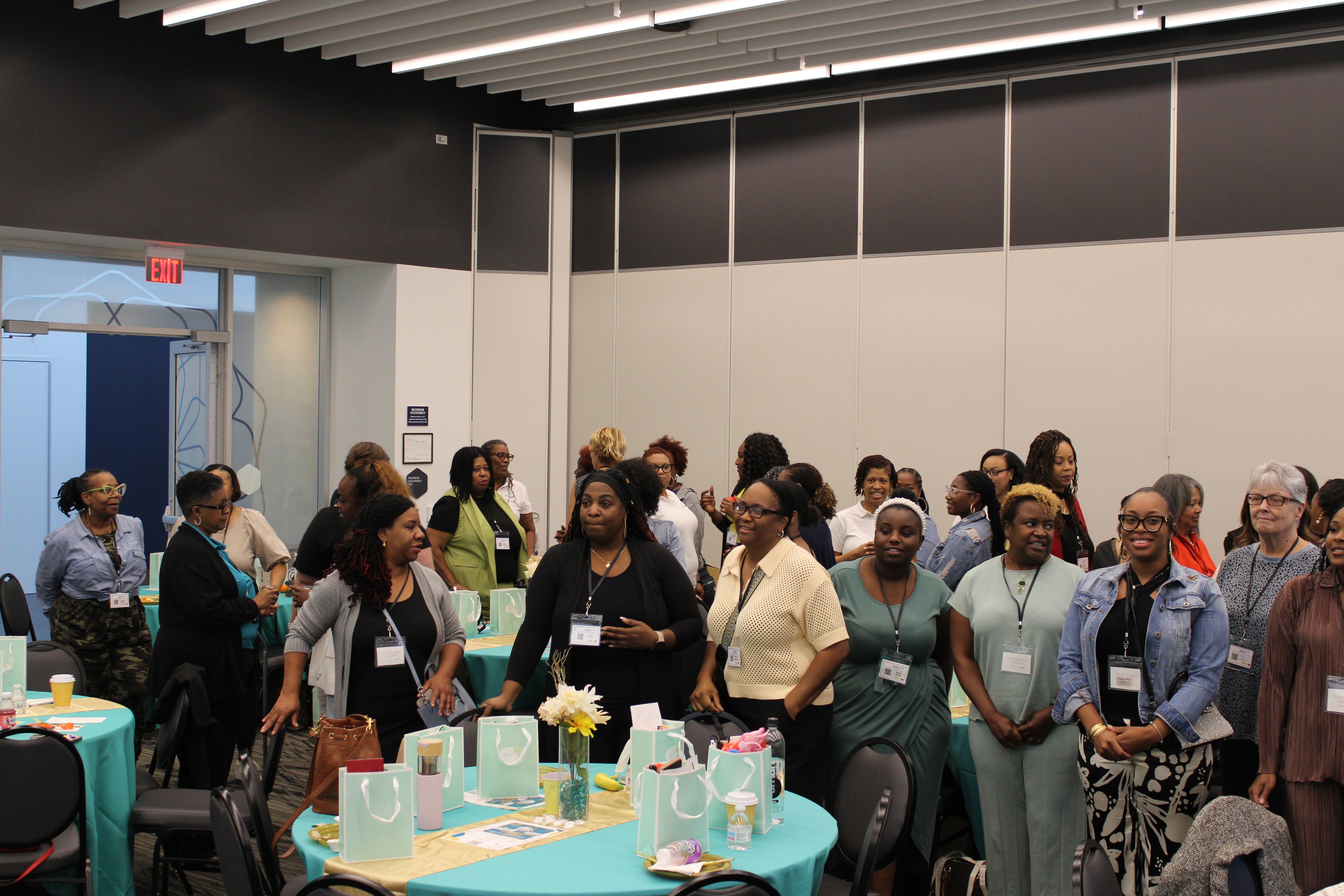 Event attendees gathered around decorated tables at a Changes Therapeutic Services event