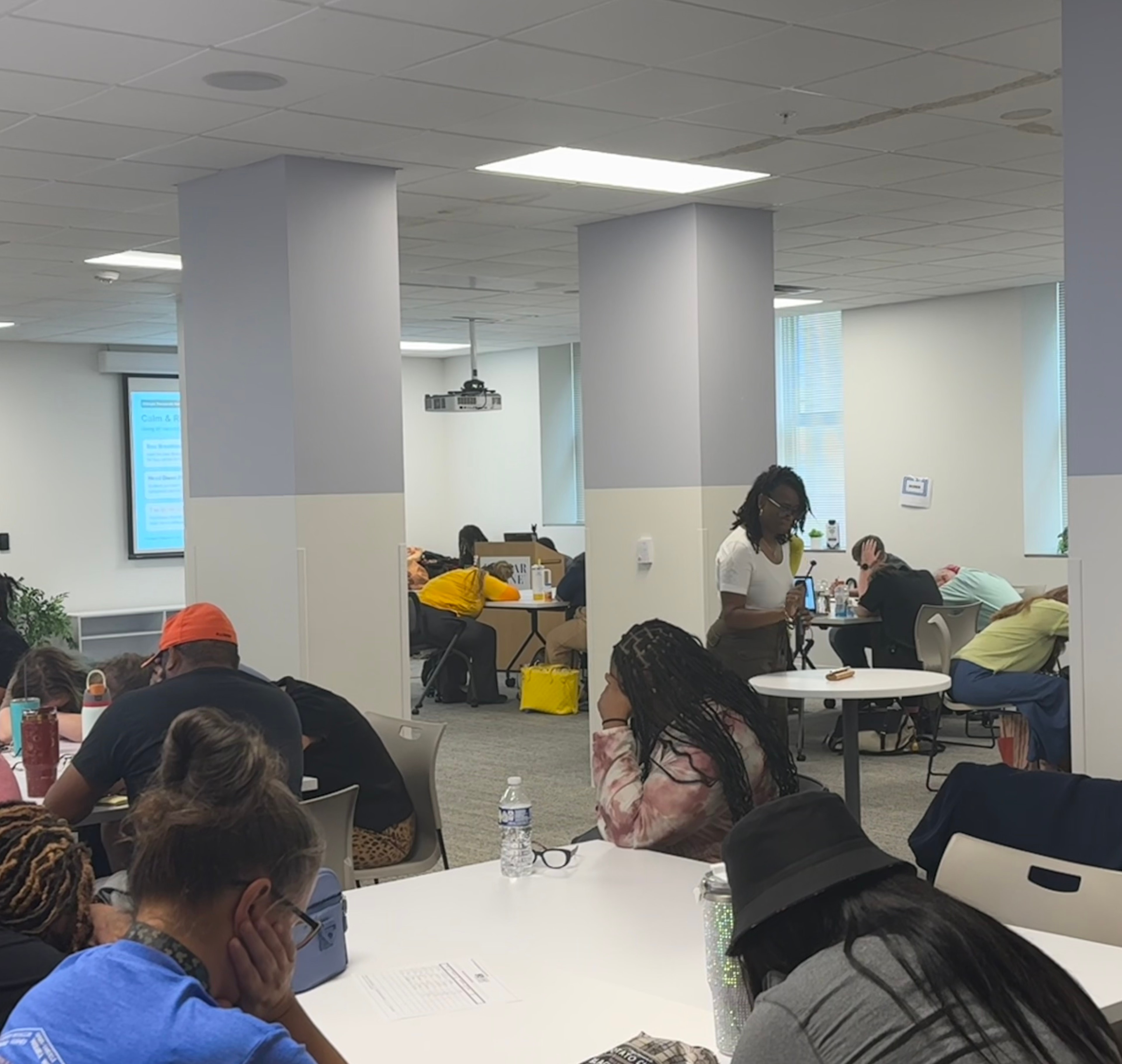 Participants seated at tables during a community training session