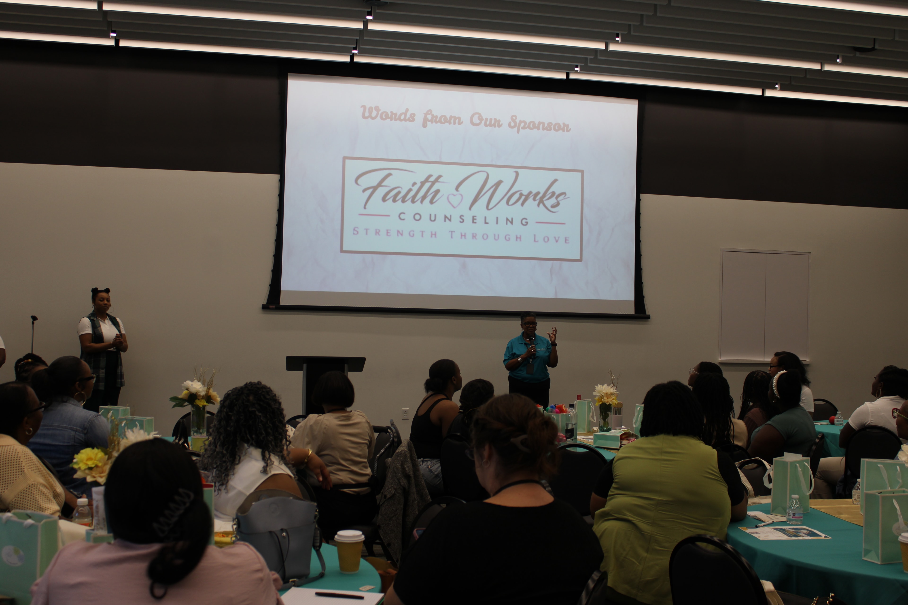 Audience attending a Faith Works Counseling presentation at a community event