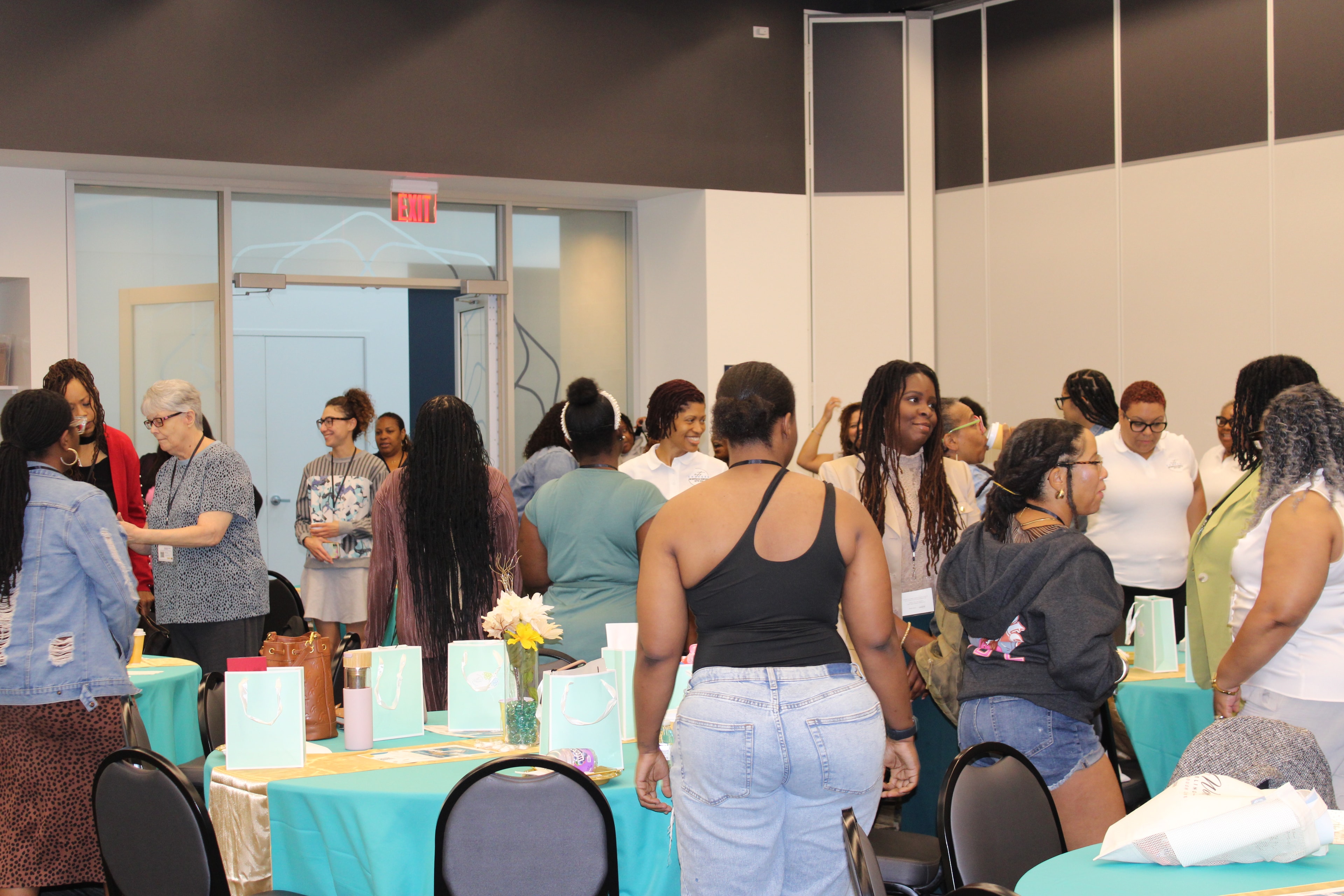 Attendees networking around decorated tables at a Changes Therapeutic Services event