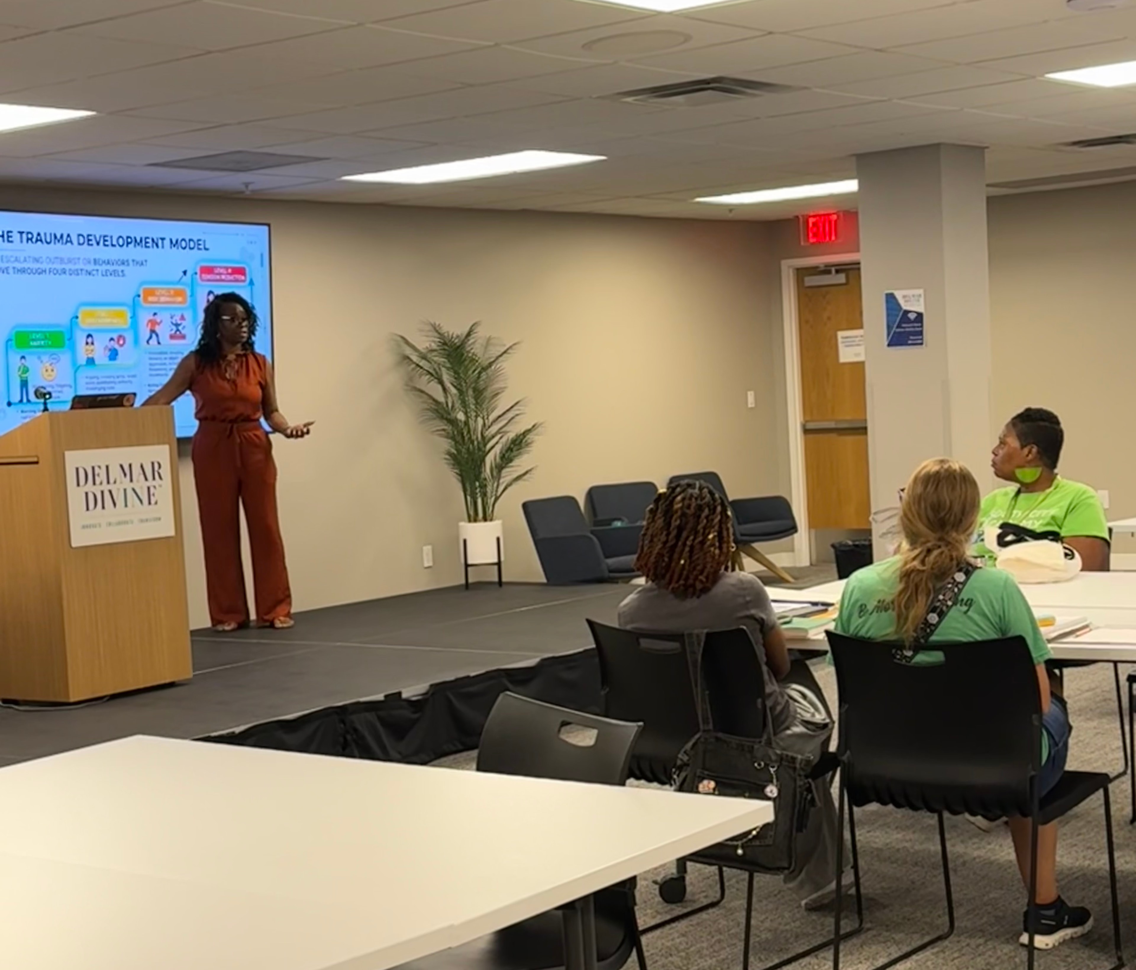 Presenter leading a trauma development model workshop for seated attendees